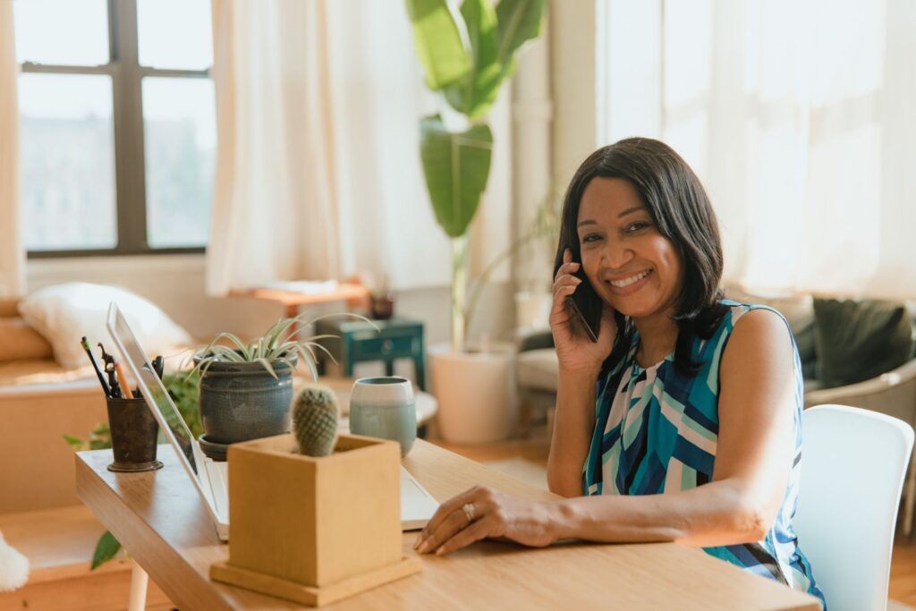 Woman talking on the phone at her desk